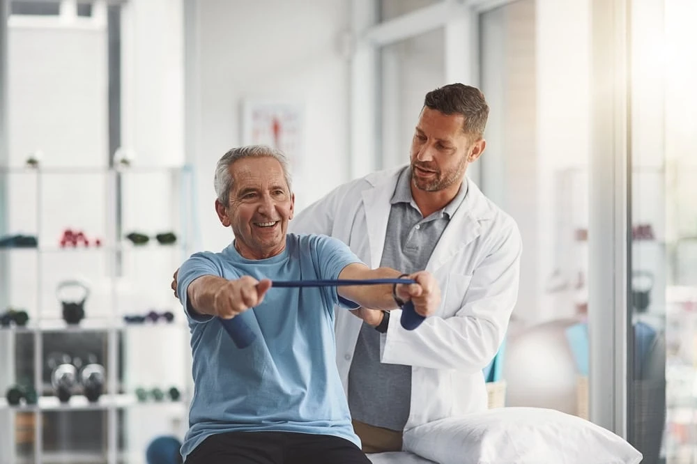 A physical therapist in NYC performing advanced rehabilitation procedures with a patient, including manual therapy, guided exercises, and mobility training for pain relief and functional recovery.