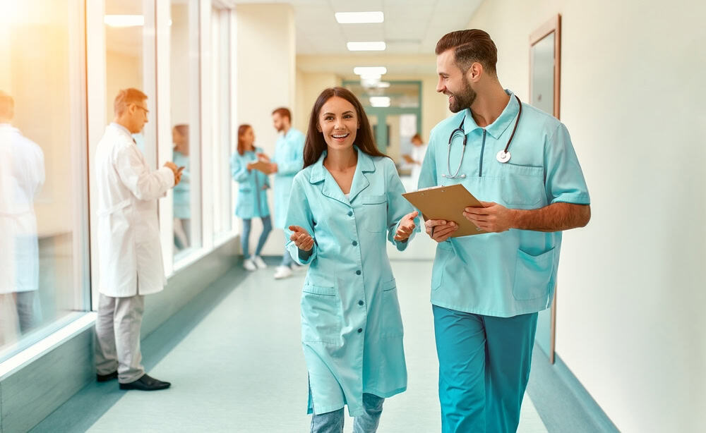 Kyphoplasty doctors in a NYC hospital hallway, representing expert spine specialists prepared to treat vertebral compression fractures with advanced, minimally invasive techniques.