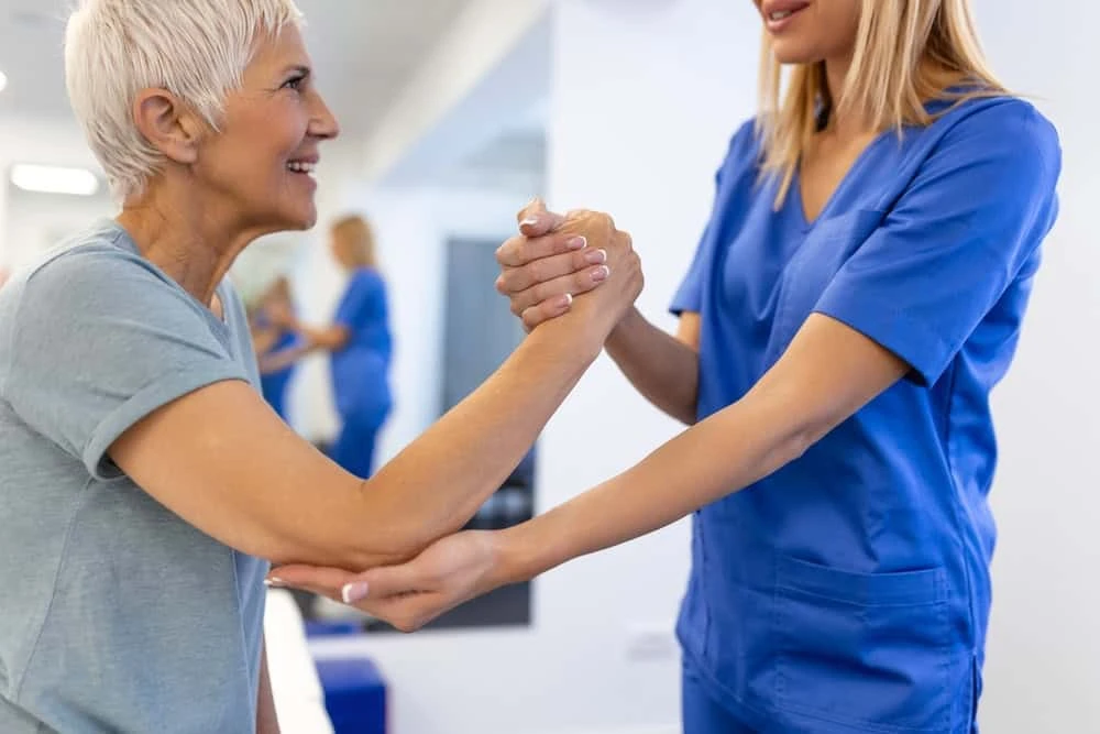 A neuropathy doctor in NYC performing a physical examination and guiding physiotherapy treatment to relieve nerve pain, focusing on hands-on care and non-invasive pain relief.